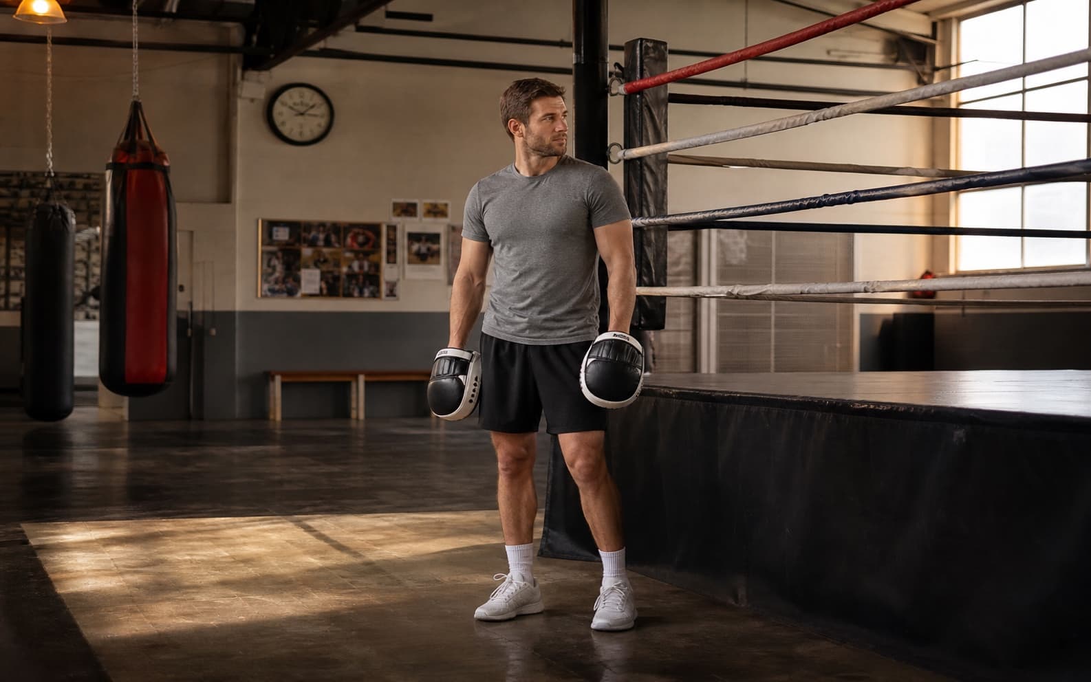 Boxing coach waiting with focus mitts for a missing athlete