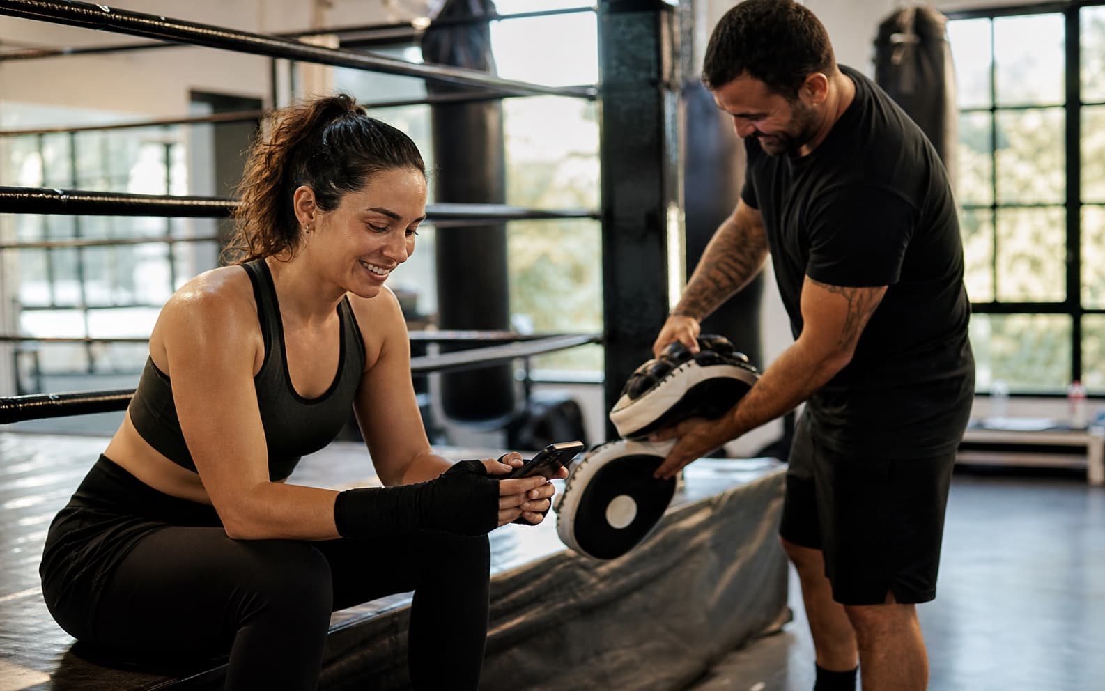 Boxing coach working mitts with an athlete